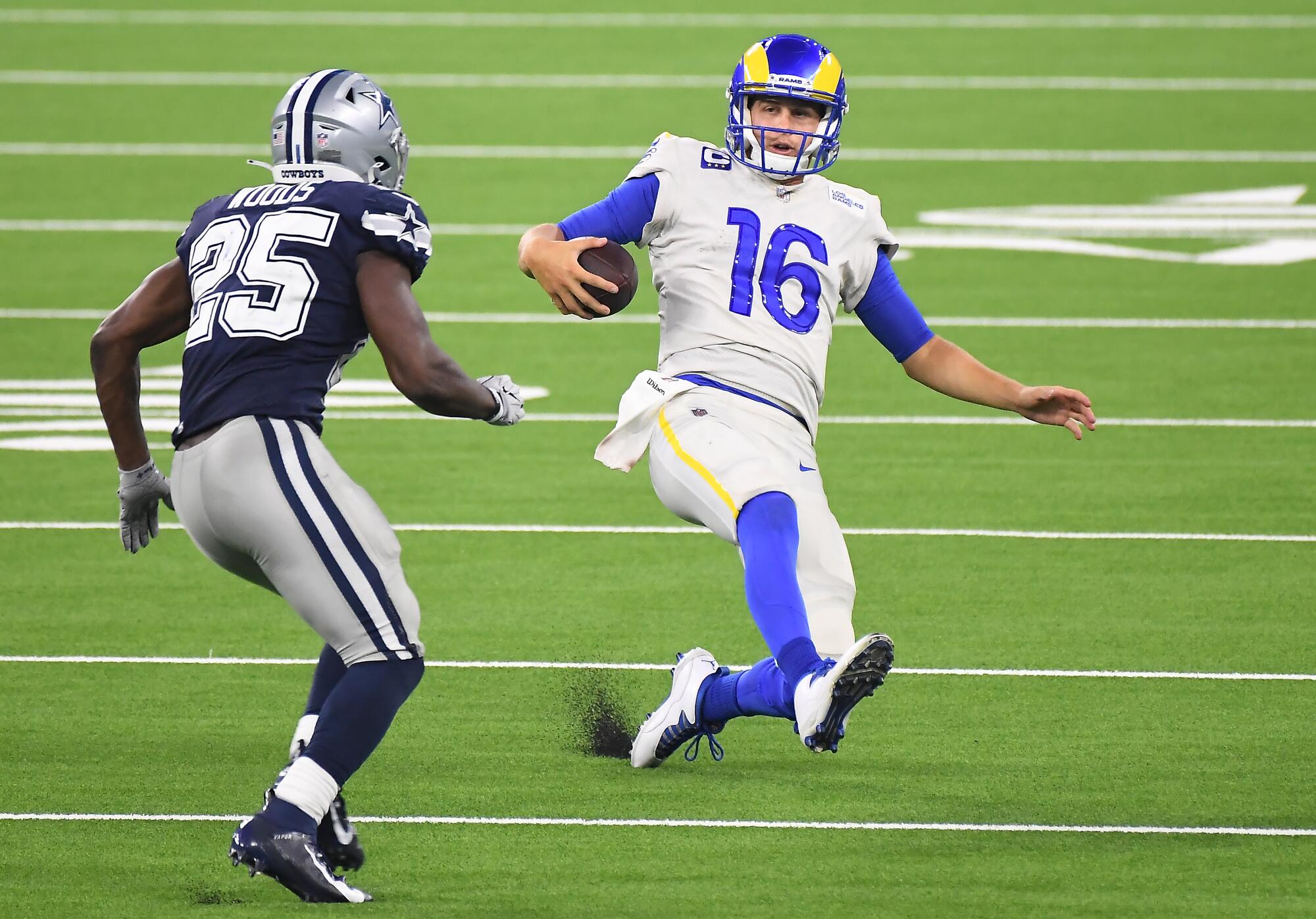Rams quarterback Jared Goff slides before being tackled by Cowboys safety Xavier Woods in the fourth quarter.