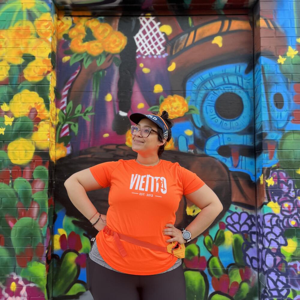 Jess Vergara, co-captain and co-founder of Viento in front of Mural.