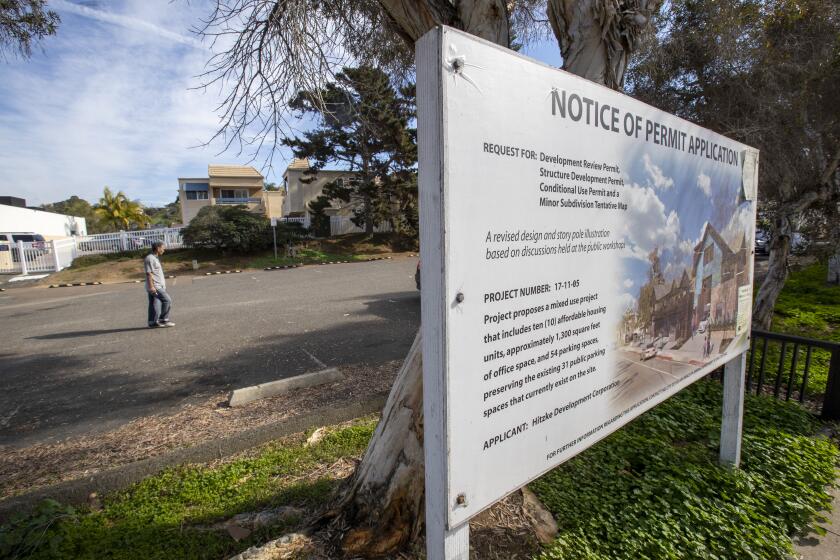 SOLANA BEACH, CALIF. -- TUESDAY, JANUARY 14, 2020: A notice of permit application sign is posted the site of a proposed affordable housing project near million-dollar condos on S. Sierra Ave, Solana Beach, a parking lot behind Sand Pebbles Resort in Solana Beach. It's a 10-unit project that has been in the works for the last 10 years and has yet to break ground in Solana Beach, Calif., on Jan. 14, 2020. (Allen J. Schaben / Los Angeles Times)