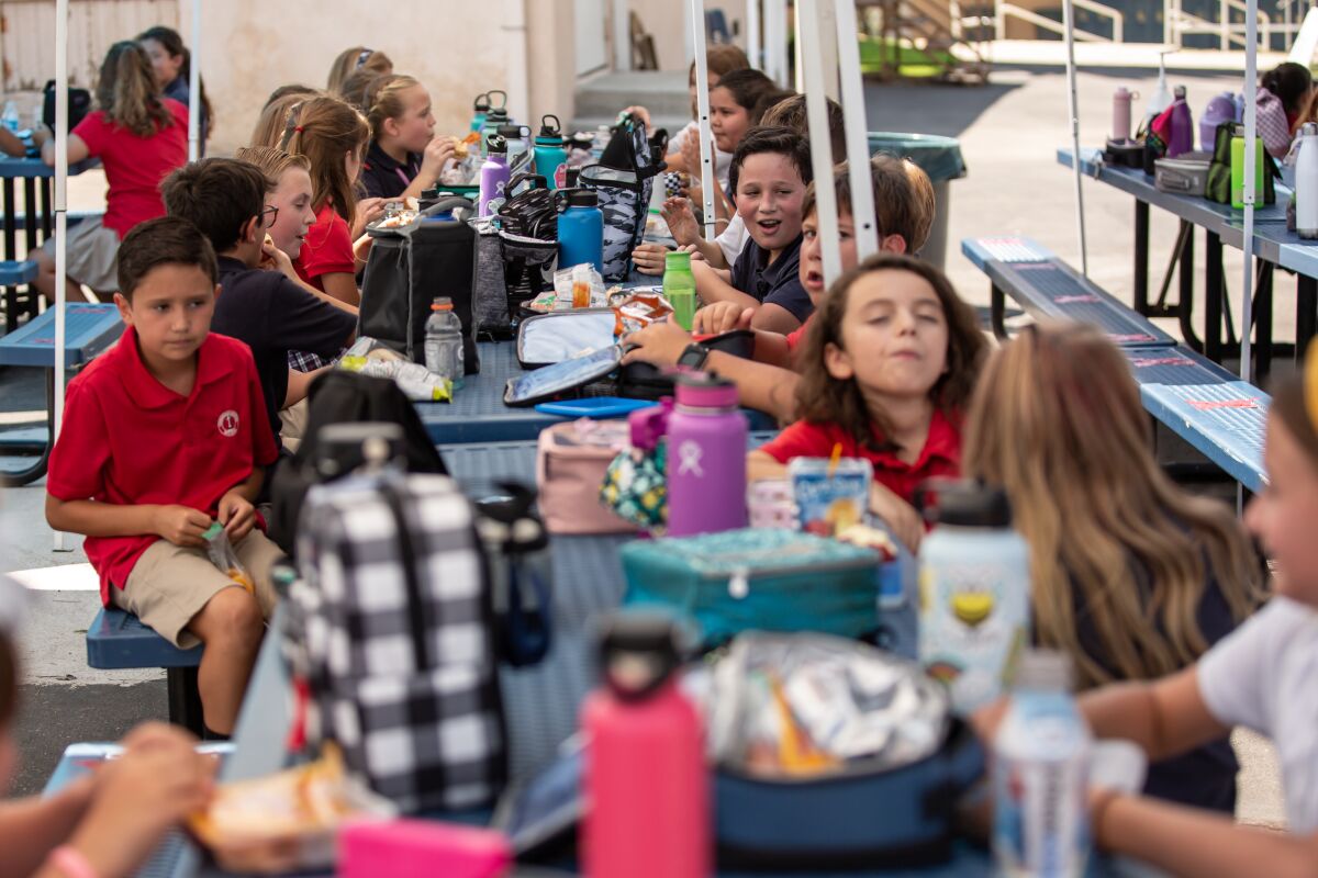 Students socialize during lunch break without masks at Christian Unified on Monday, Aug. 24, 2020 in El Cajon