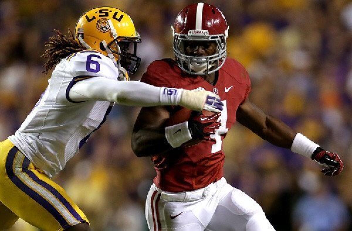 Although Alabama's T.J. Yeldon couldn't escape the tackle of LSU's Craig Loston on this play, the Crimson Tide escaped the game with a 21-17 victory.