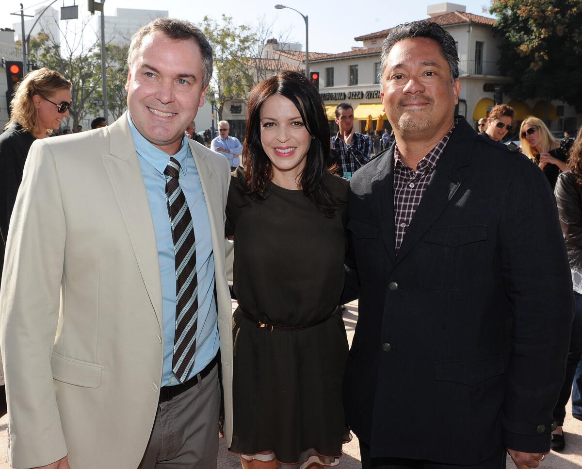 Director Chris Miller, left, producer Latifa Ouaou and producer Joe M. Aguilar arrive at the premiere of "Puss In Boots" on Oct. 23, 2011, in Westwood. Aguilar is jumping ship to become chief executive of a new animation subsidiary of the Chinese studio Huayi Bros.