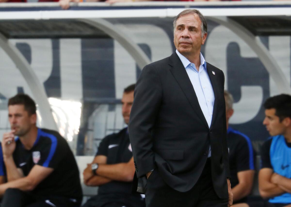 Bruce Arena watches from the sideline while coaching the U.S. men's national team during a World Cup qualifying match.