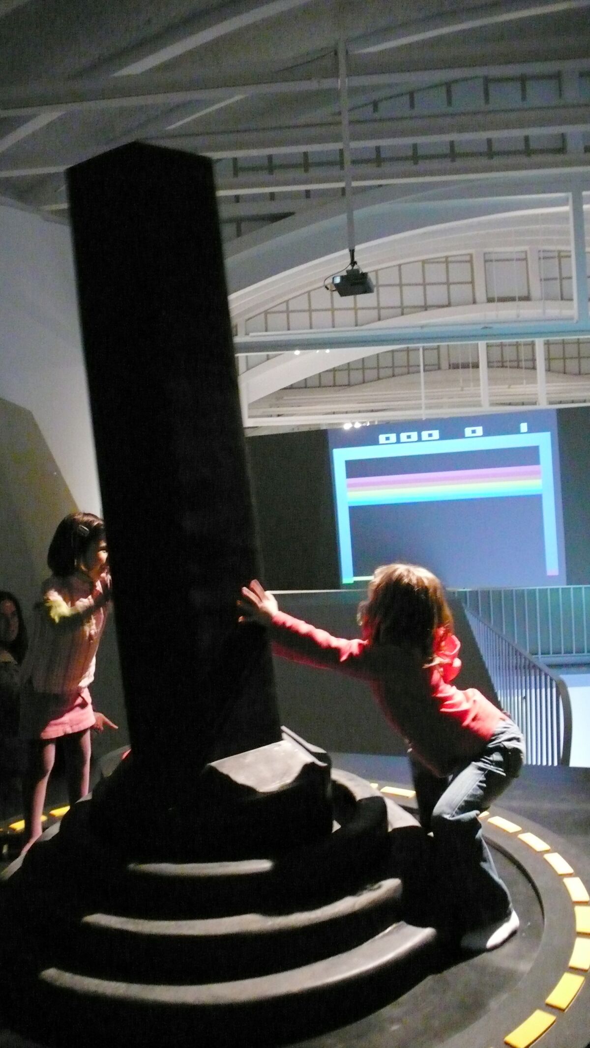 Two girls operate the Giant Joystick at LABoral Art and Industrial Creation Centre, March 31, 2007 in Asturias, Spain. The giant video game controller made of wood, rubber and steel by a Dartmouth College professor Mary Flanagan has made it into the Guinness World Records 2022 as the largest joystick. Flanagan created the controller in 2006 to celebrate her childhood experience of playing Atari 2600 video games. (Mary Flanagan via AP)