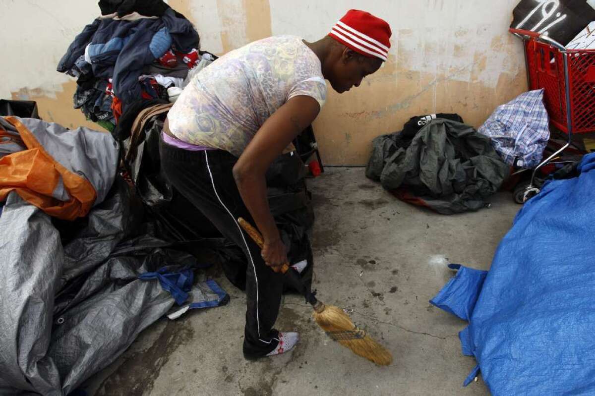 Skid row homeless clean up their overnight encampments in 2012 photo.