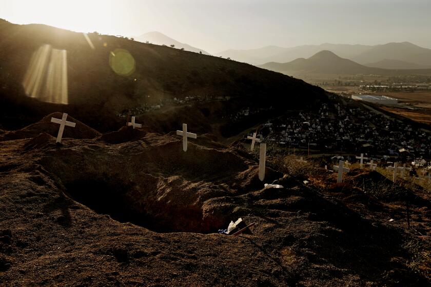 TIJUANA, BAJA CALIF. -- MONDAY, JUNE 4, 2018: A cluster of mass graves where unidentified bodies, a majority of them victims of homicides related to drug violence, are buried at Panteon (accent over the o) Municipal Numero (accent over the u) 12 in colonia La Presa, Tijuana, Baja Calif., on June 4, 2018. Roughly 120-140 bodies are transported monthly, buried 20 deep in each grave, from the morgue at the Medical Forensic Service, El SEMEFO (Servicio Médico Forense). In 2018, Tijuana, a population of roughly 1.8 million people, tallied 2518 homicides, the most ever recorded in a Mexican City. With 133 killings for every 100,000 people, it is now one of the deadliest cities in the world. The force behind the killings is competition among Mexican cartels fighting over the local drug market. (Gary Coronado / Los Angeles Times)