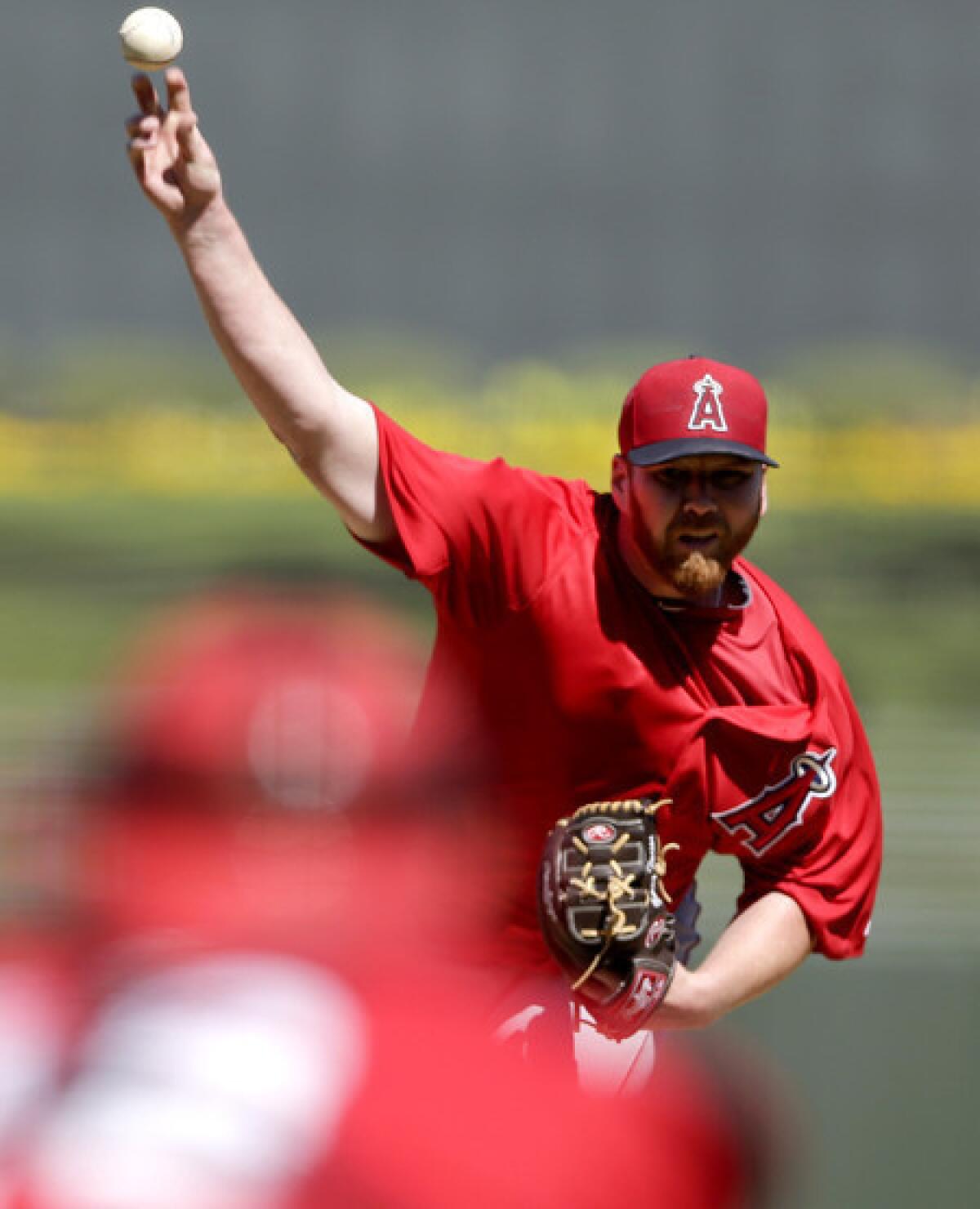 Angels starter Tommy Hanson pitches against the Kansas City Royals in an exhibition game earlier this month.