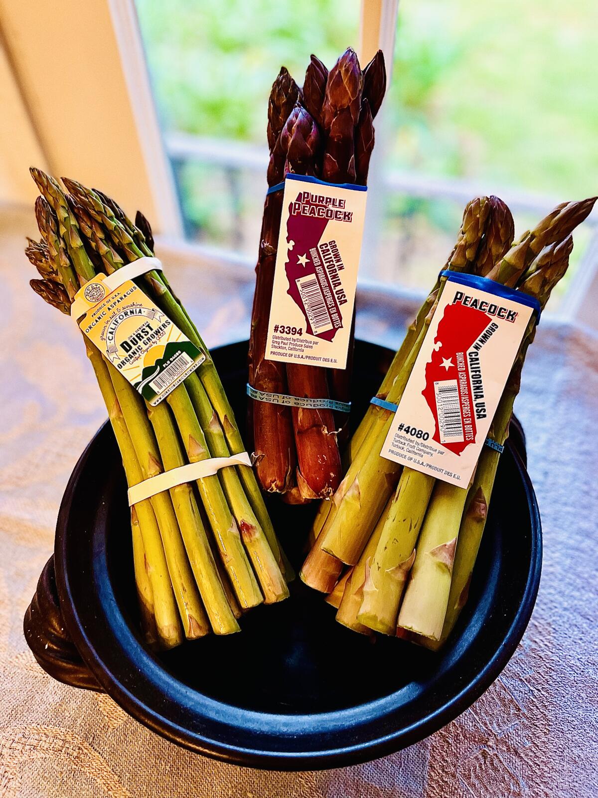 Three bundles of California-grown asparagus.