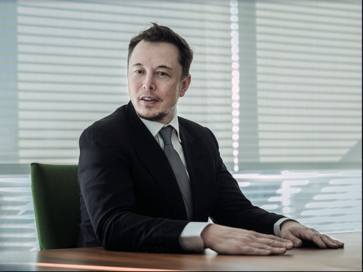 A man in a suit at a conference room table
