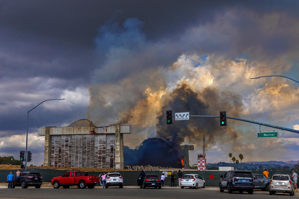 A stubborn fire burns a hangar at the former Tustin Air Base on Nov. 7.  