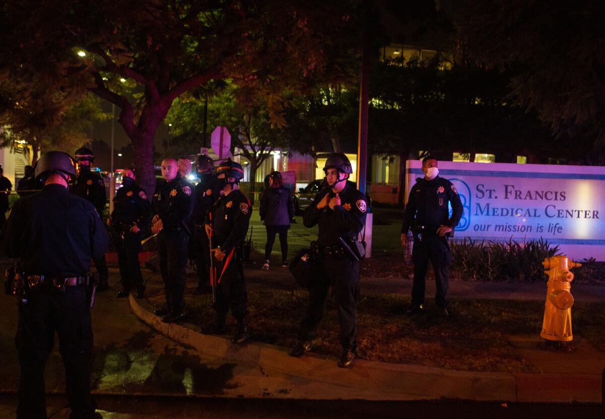 Sheriff's deputies stand guard outside St. Francis Medical Center, where two deputies were being treated.