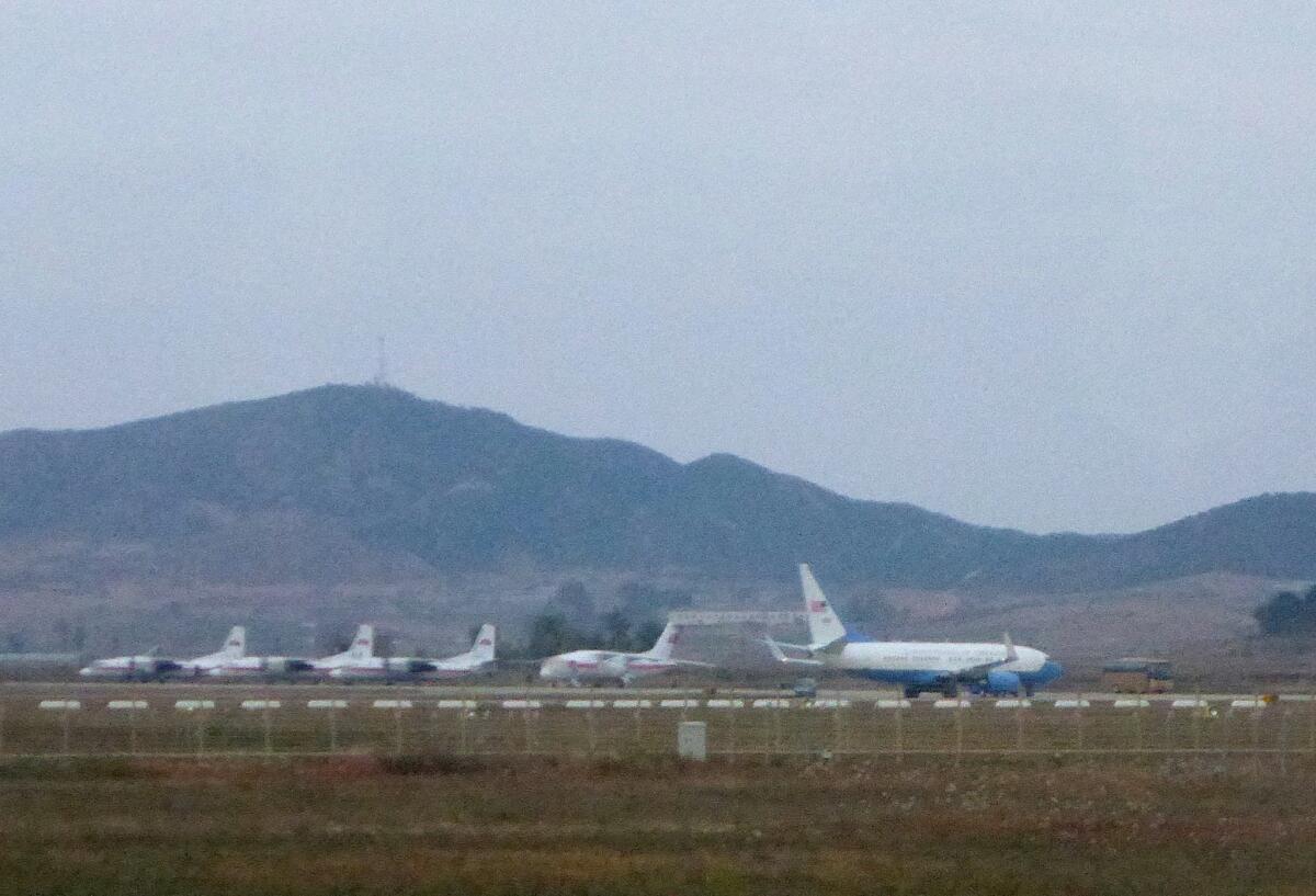 What appears to be an Air Force passenger jet, right, is parked on the tarmac of the international airport in Pyongyang, North Korea, on Oct. 21, the same day Jeffrey Fowle, one of three Americans being held in North Korea, was released.