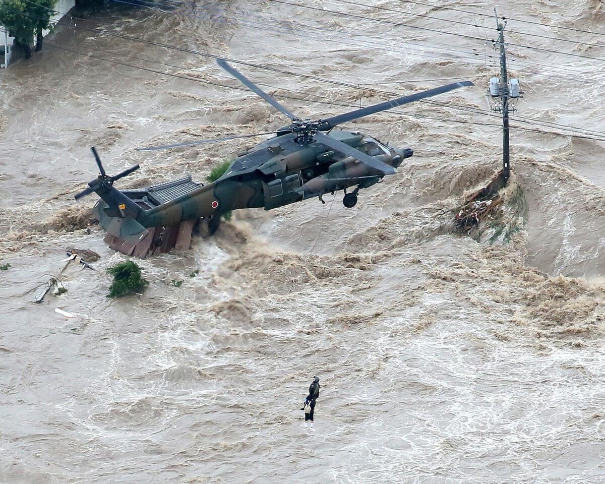 A Ground Self-Defense Force helicopter rescues a resident in a flooded area in Joso, Japan, on Sept. 10.