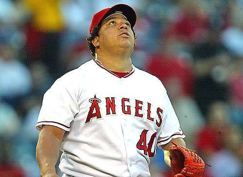 Angel starting pitcher Bartolo Colon watches his first pitch get driven by the New York Yankees' Derek Jeter for a triple over the right fielder's head.