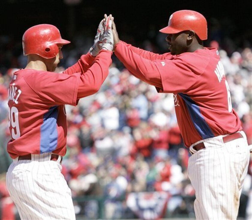 Philadelphia Phillies left fielder Raul Ibanez, left, celebrates with Ryan Howard after his two-run homer in the fourth inning of an exhibition baseball game with the Tampa Bay Rays, Saturday, April 4, 2009, in Philadelphia. (AP Photo/Tom Mihalek)