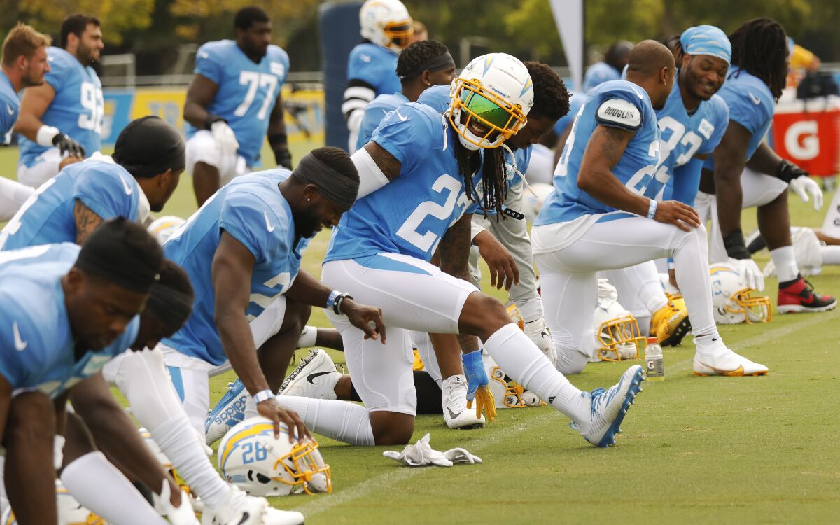 Chargers players stretch during training camp in Costa Mesa on Monday.