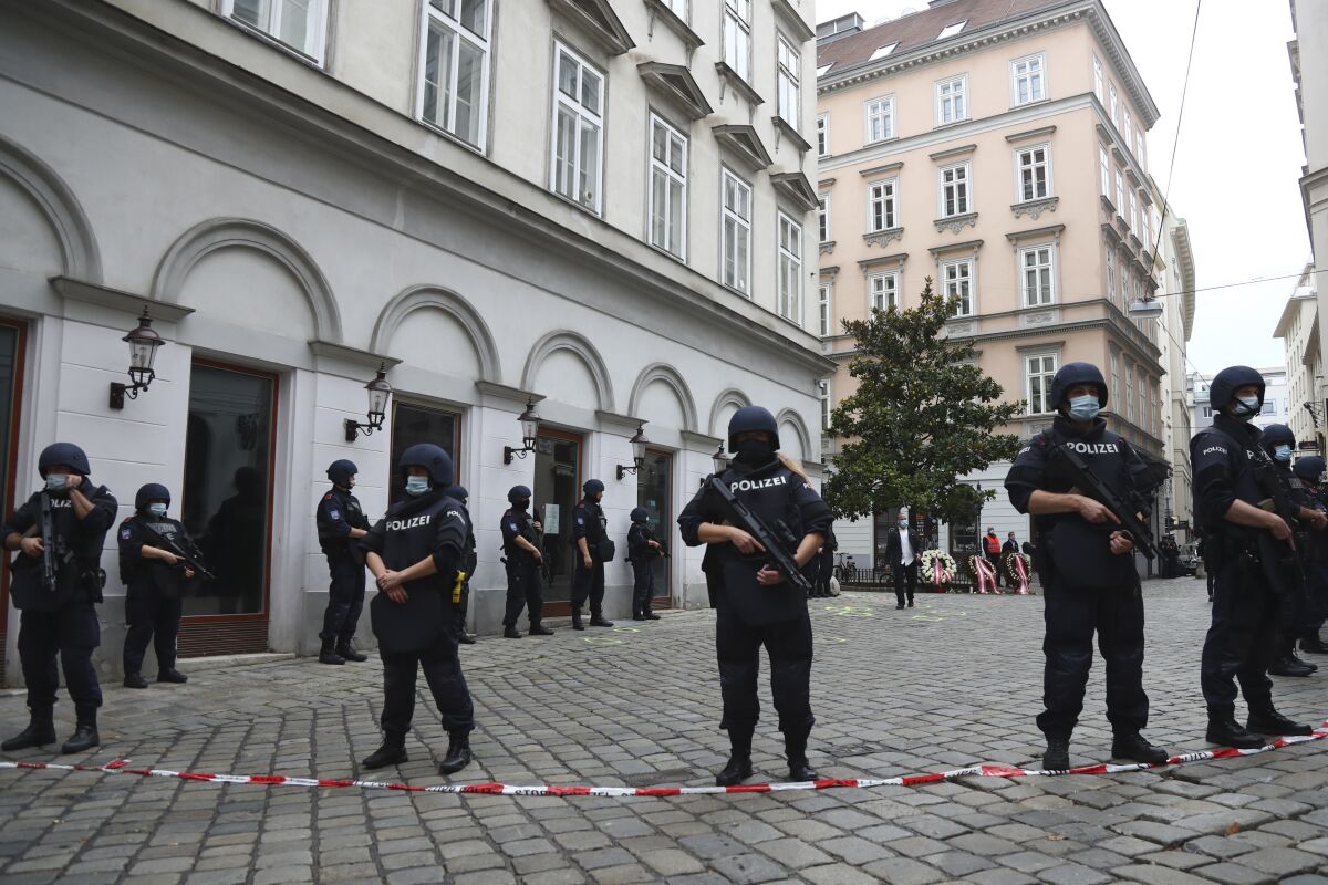 Police officers guard the scene in Vienna, Austria, Tuesday, Nov. 3, 2020. Police in the Austrian capital said several shots were fired shortly after 8 p.m. local time on Monday, Nov. 2, in a lively street in the city center of Vienna. Austria's top security official said authorities believe there were several gunmen involved and that a police operation was still ongoing. (AP Photo/Matthias Schrader)