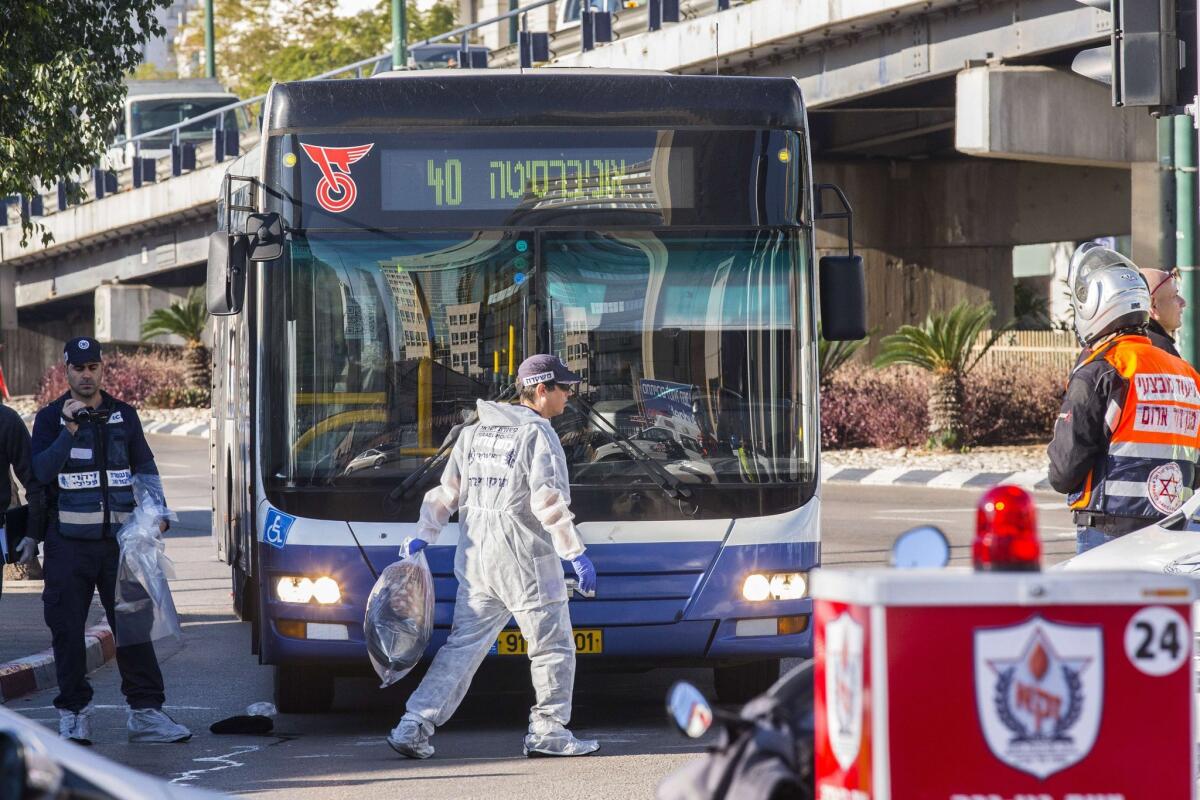 Authorities examine the scene of a stabbing attack on a Tel Aviv bus on Jan. 21.