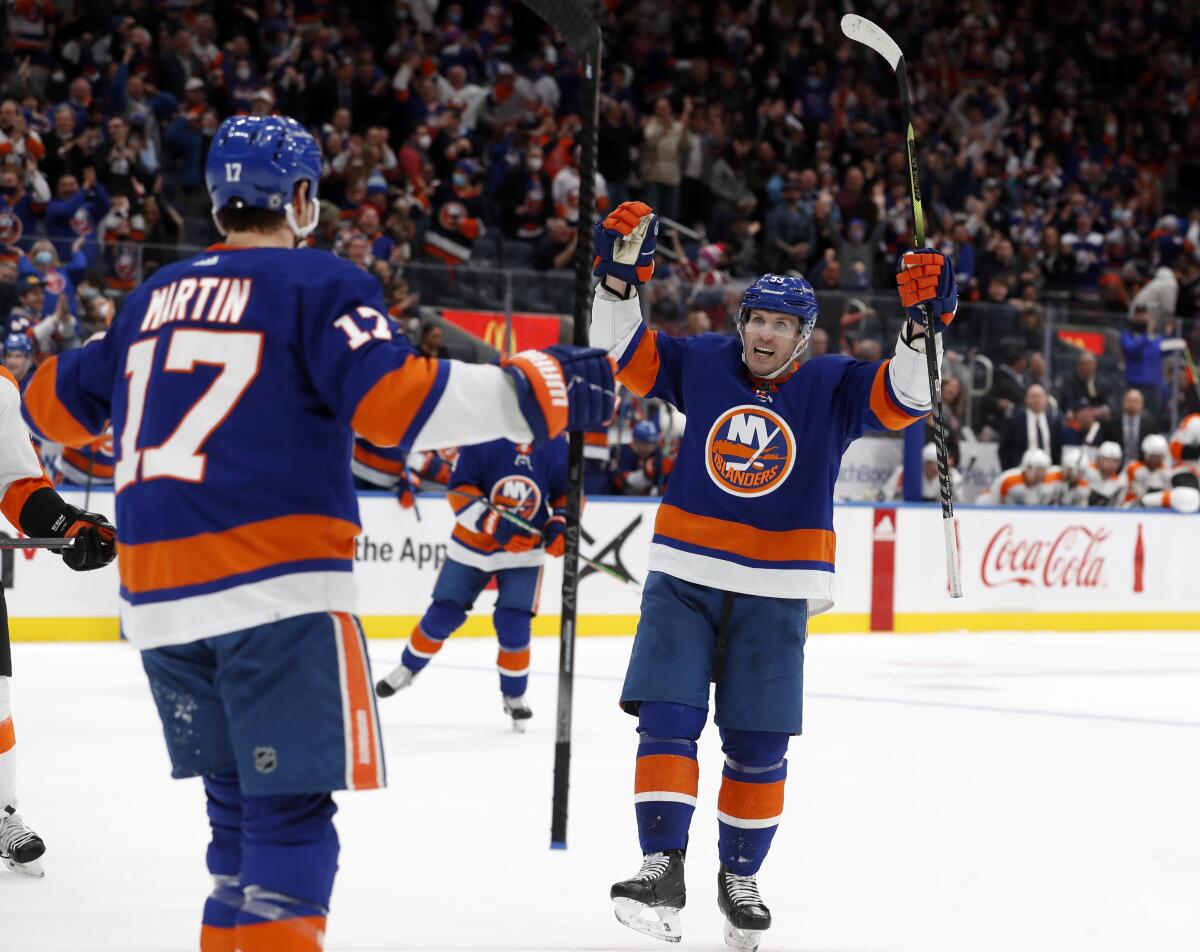 New York Islanders center Casey Cizikas (53) celebrates after his goal in the second period of an NHL hockey game against the Philadelphia Flyers with teammate left wing Matt Martin (17) on Monday, Jan. 17, 2022, in Elmont, N.Y. (AP Photo/Jim McIsaac)