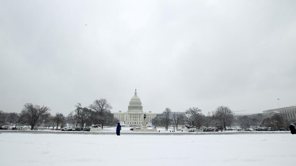 People walk outside of the U.S. Capitol building in Washington on Jan. 13.