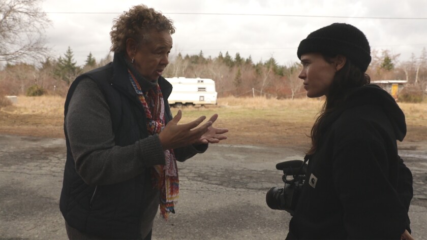 Ellen Page interviews an activist about the long-term effects of a dump in her neighborhood in the documentary 'There's Something in the Water'