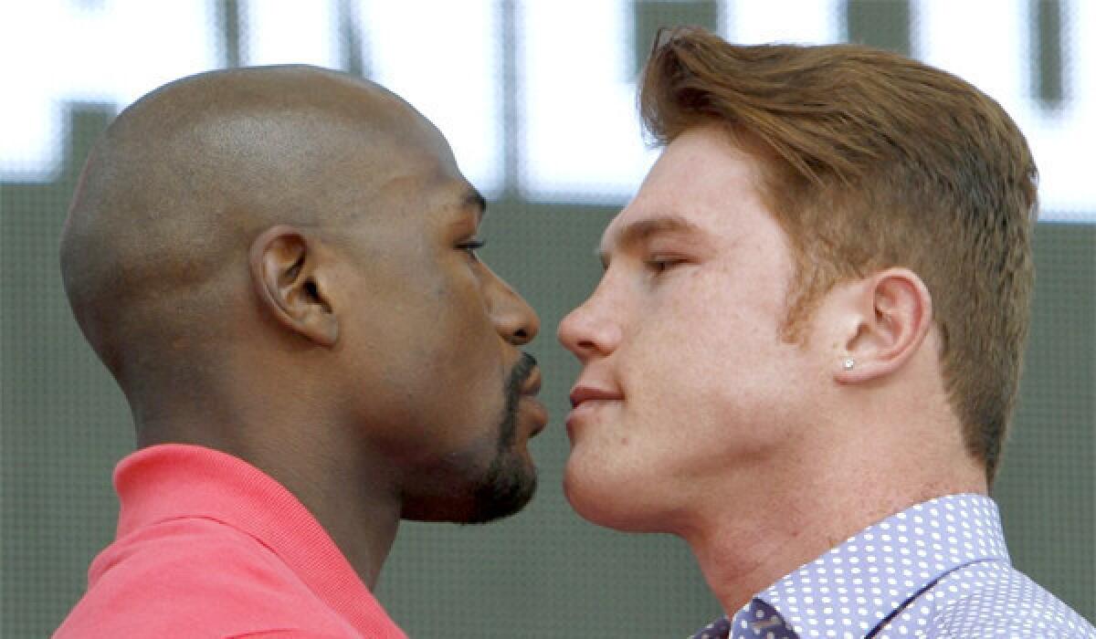 Floyd Mayweather Jr. and Saul "Canelo" Alvarez stare each other down during a news conference in Mexico City on Tuesday, the boxers will square off in the ring on Sept. 14 in Las Vegas.