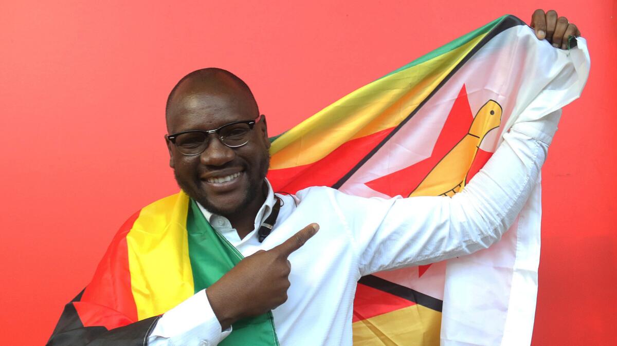 Evan Mawarire posing with the Zimbabwean flag in Harare on May 3, 2016.