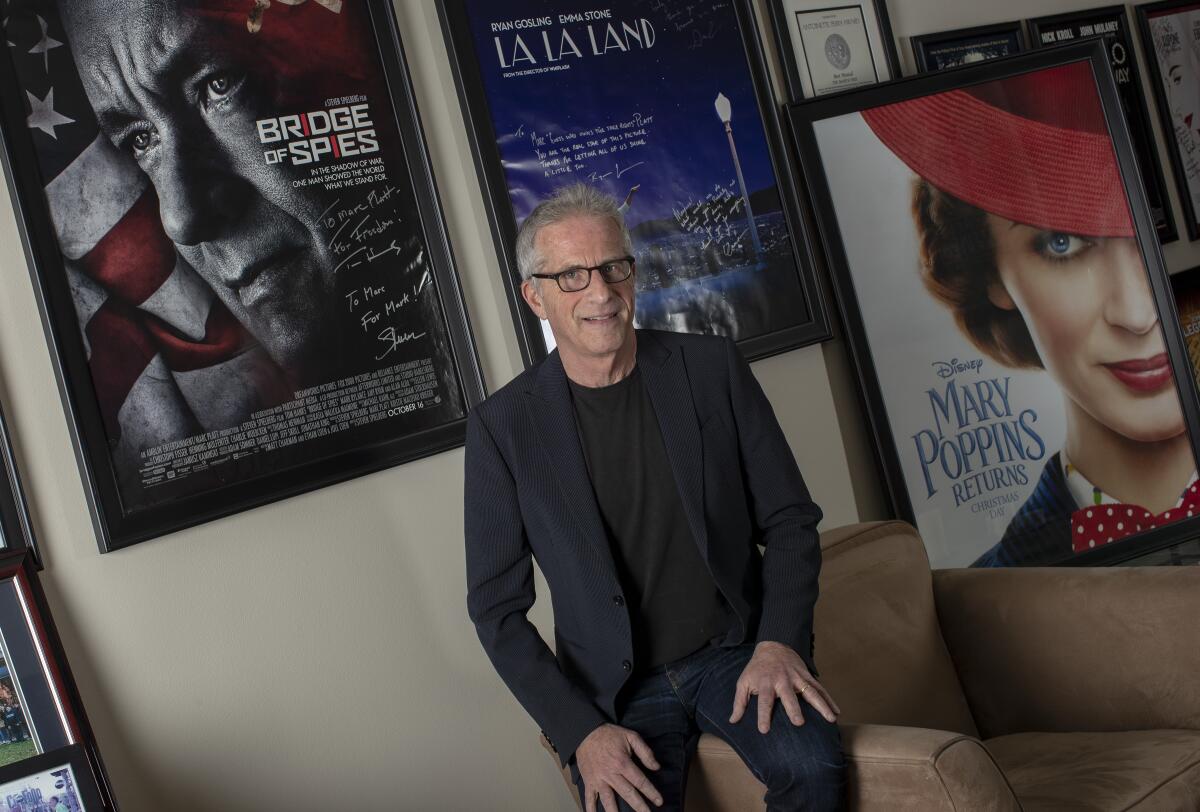 Marc Platt, surrounded by large movie posters