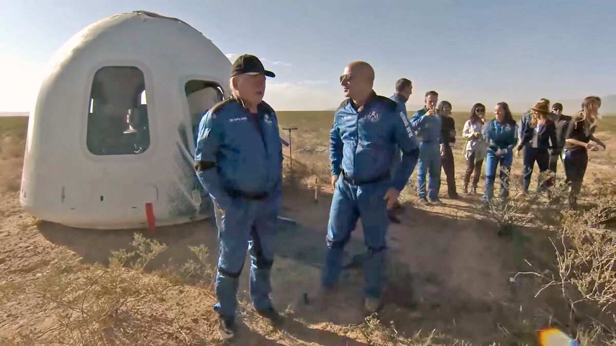 Jeff Bezos talks to William Shatner after Blue Origin's New Shepard crew capsule landed back in Texas