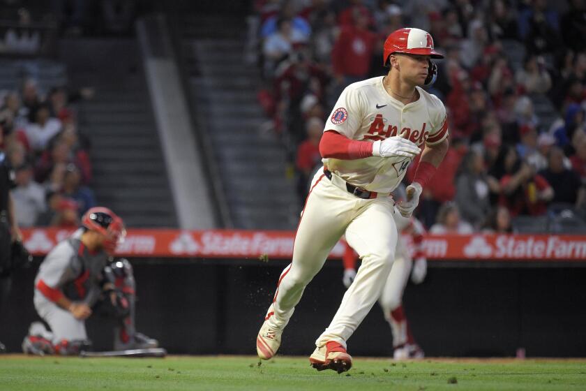 Los Angeles Angels' Logan O'Hoppe, right, heads to first after hitting a three-run home run as St. Louis Cardinals catcher Pedro Pages watches during the fourth inning of a baseball game Tuesday, May 14, 2024, in Anaheim, Calif. (AP Photo/Mark J. Terrill)