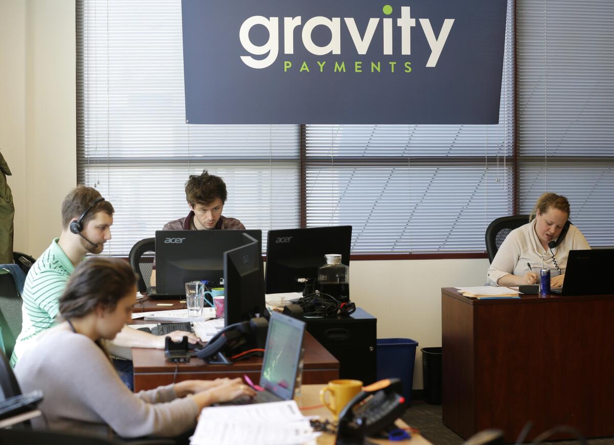 Sales representatives at Gravity Payments, where Chief Executive Dan Price says he will slash his own salary and boost that of employees.