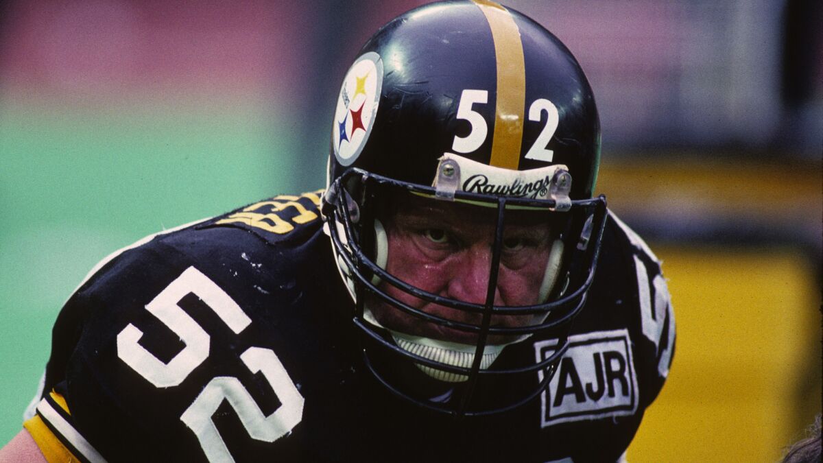 Pittsburgh Steelers center Mike Webster looks on from the sideline during a game in December 1988. Webster, who died from a heart attack in 2002 at age 50, suffered from a neurodegenerative disease.