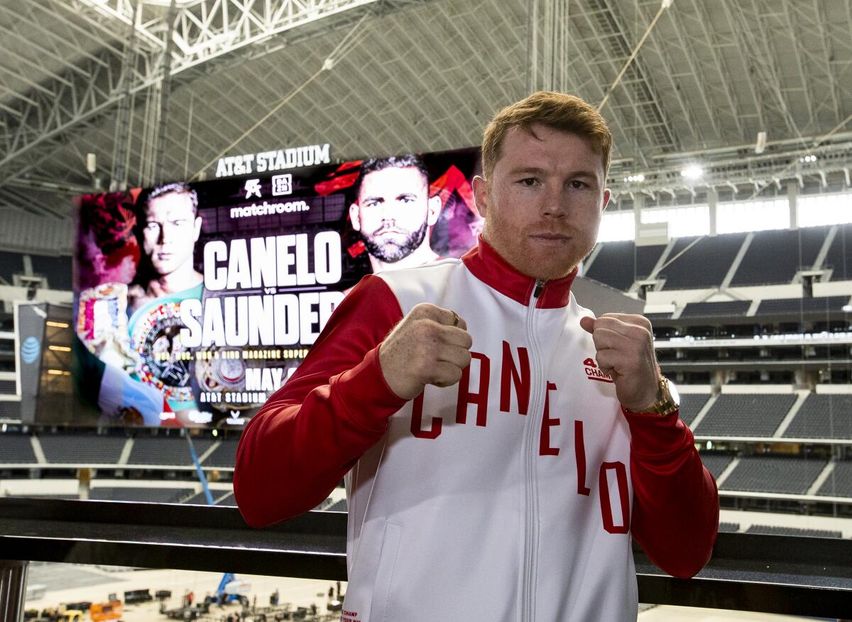 Saúl "Canelo" Álvarez poses in front a scoreboard promoting his fight with Billy Joe Saunders