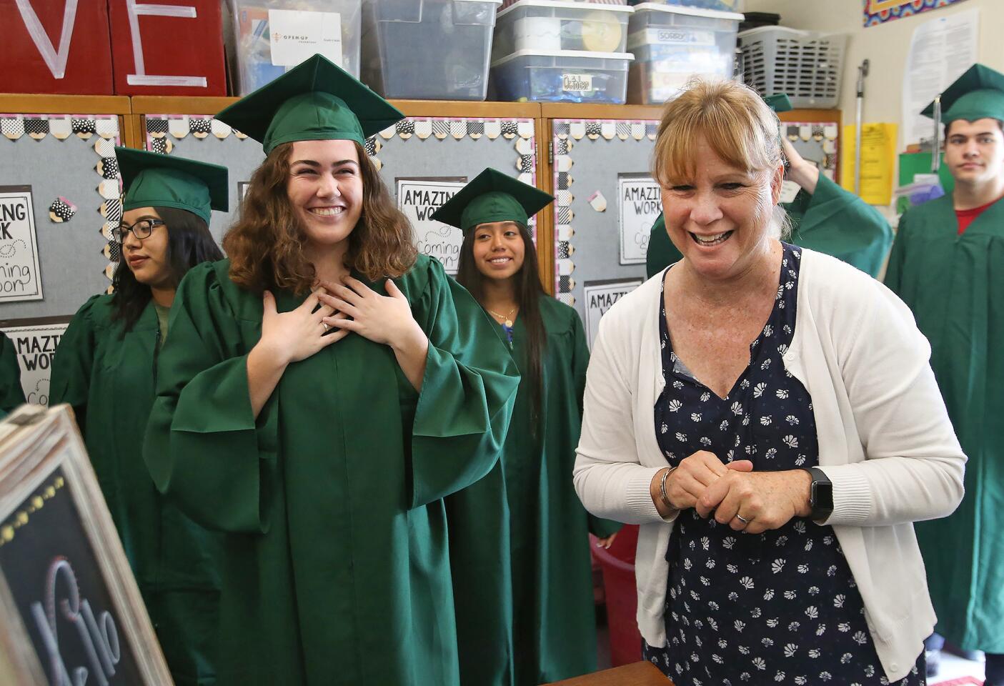 Graduating Costa Mesa High School senior Haley Wolf, left in foreground, reacts to seeing her sixth-grade teacher, Susie Farnsworth, as Wolf and other Sonora Elementary School alumni visit the school for the annual grad walk Wednesday.
