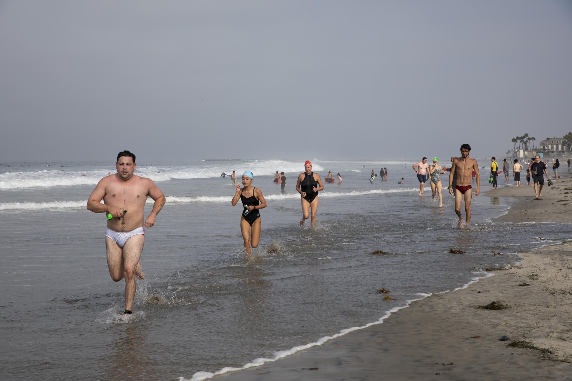 About 450 swimmers plunge into 65 degree water during the Annual Labor Day Pier Swim.