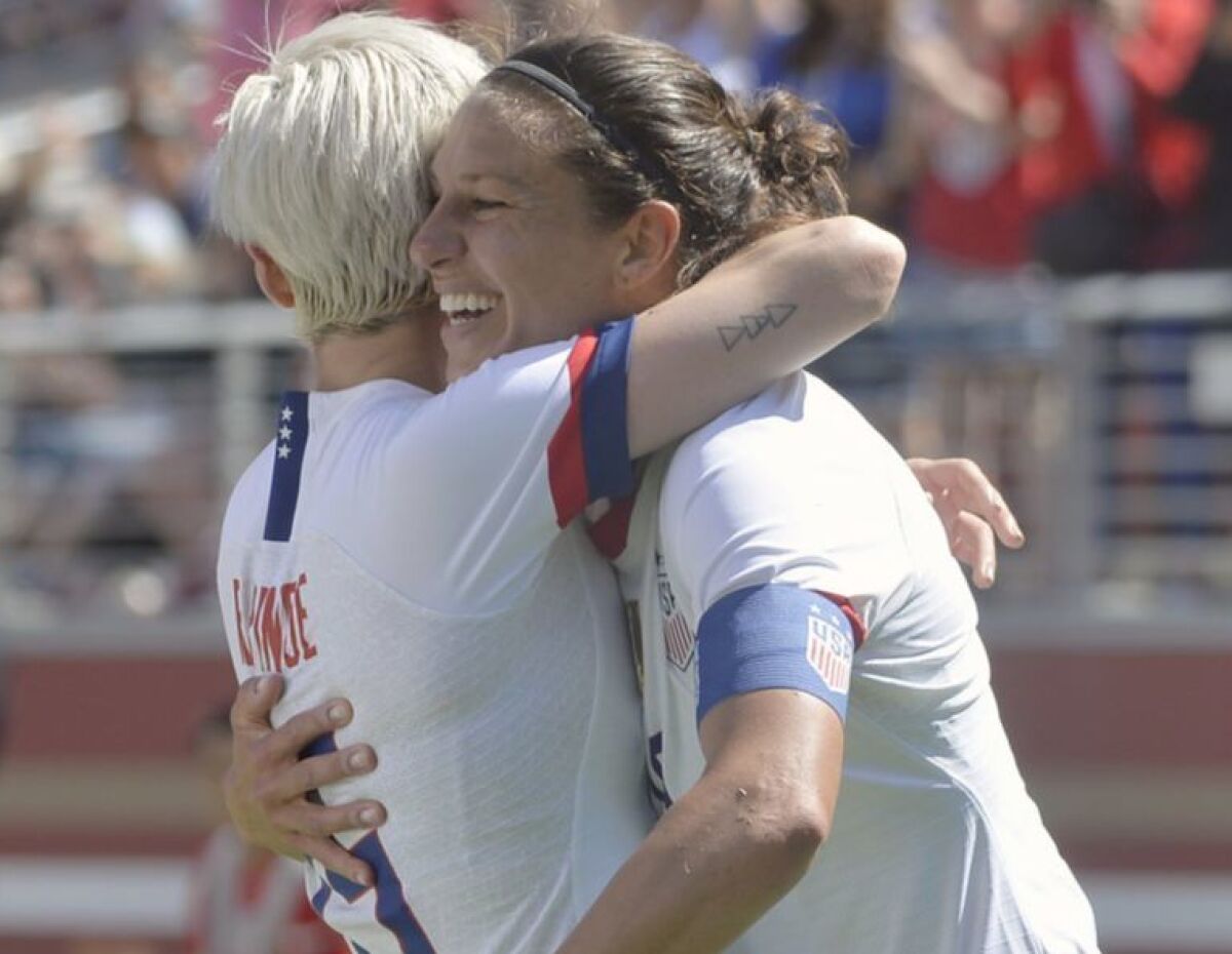 Carli Lloyd, right, gets a hug from teammate Megan Rapinoe after scoring a goal for the U.S.