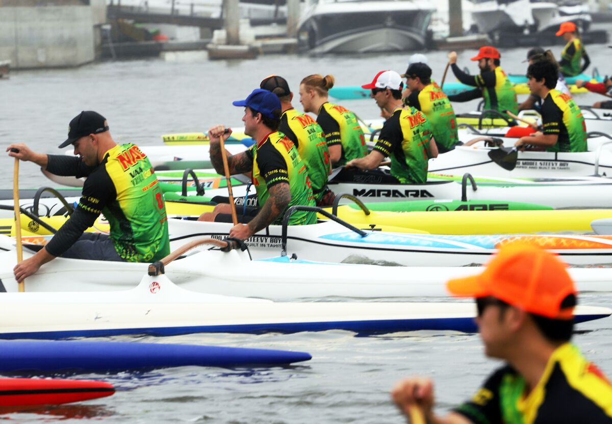 About 50 professional paddlers position themselves for the start of a qualifying race in Newport Harbor.