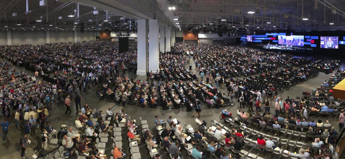 People fill a massive room at a Southern Baptist Convention meeting.