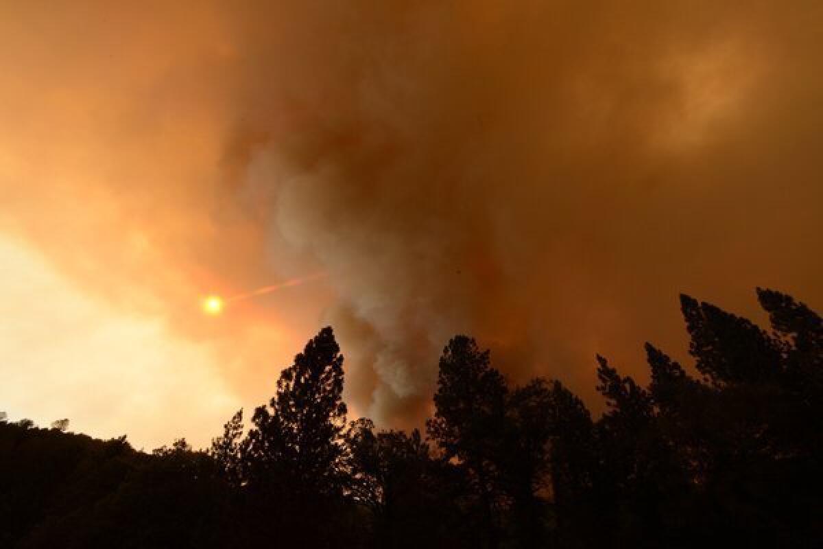 Large plumes of smoke from the Carstens fire block the sun in the Sierra National Forest. The blaze had burned more than 1,800 acres and was 40% contained Tuesday night.
