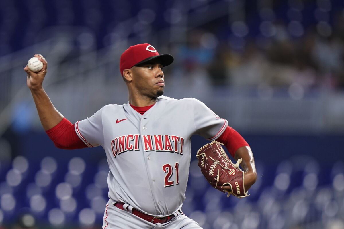 Cincinnati Reds' Hunter Greene delivers a pitch during the first inning of a baseball game against the Miami Marlins, Monday, Aug. 1, 2022, in Miami. (AP Photo/Wilfredo Lee)
