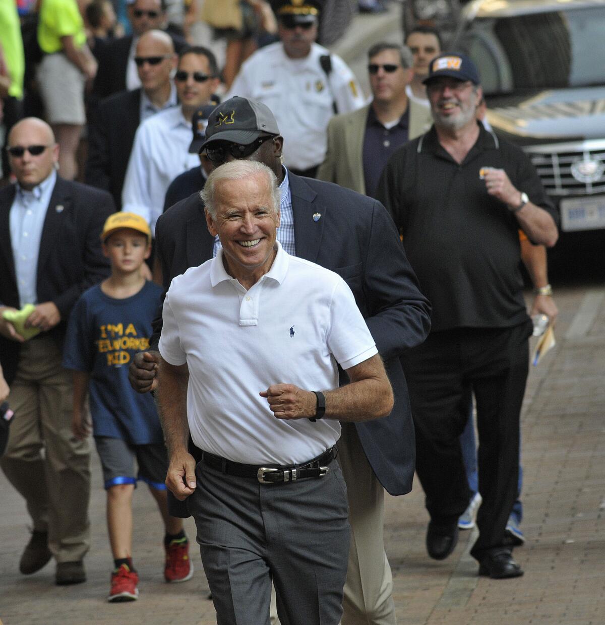 Vice President Joe Biden greets people as he walks along the Labor Day parade route in Pittsburgh.