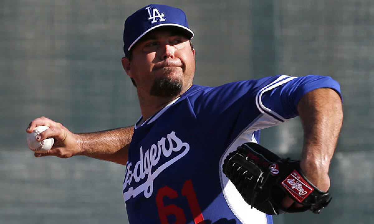 Dodgers pitcher Josh Beckett, shown throwing during a practice session last month, pitched two innings in Sunday's exhibition game against the San Diego Padres.