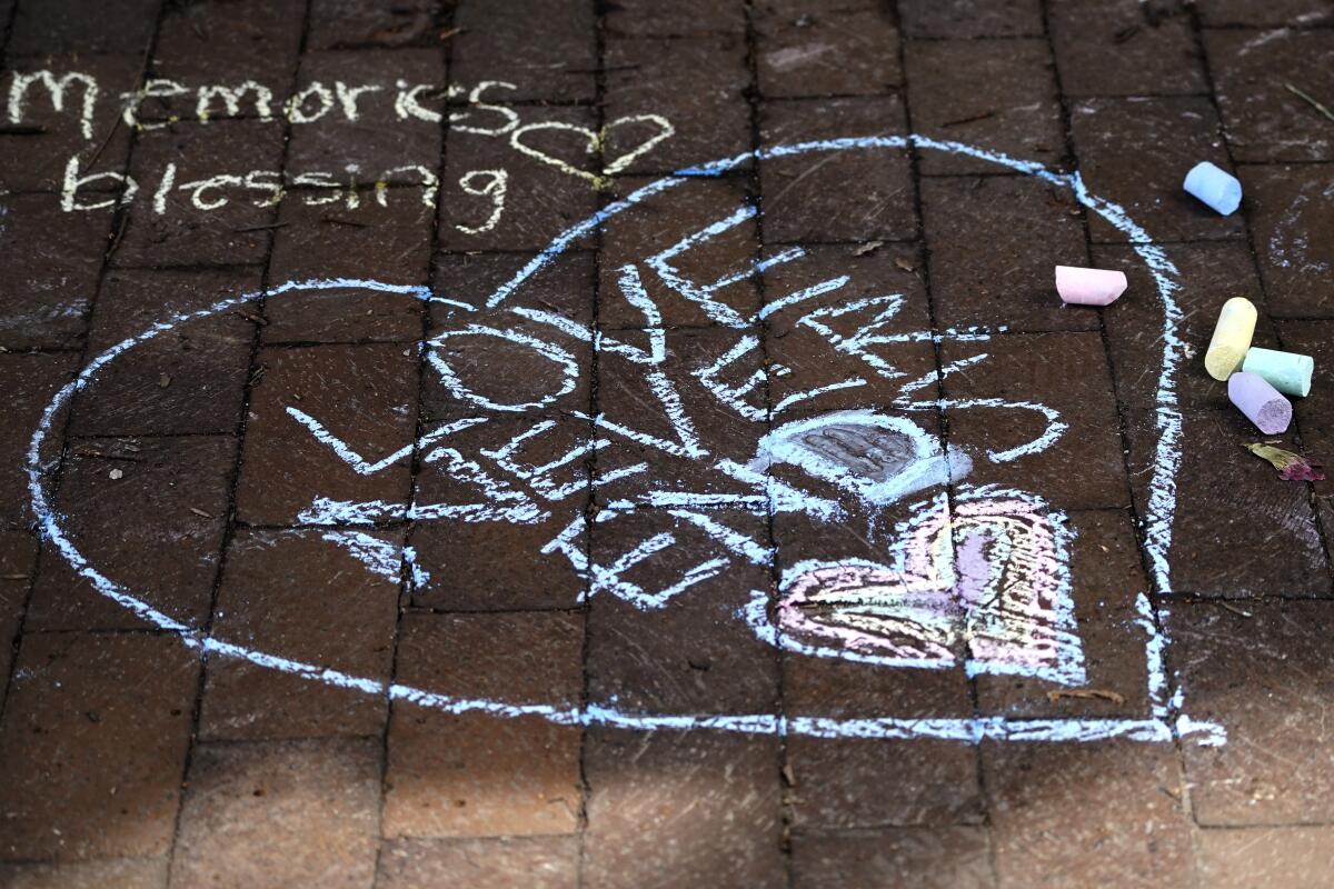 Messages in chalk are written on a sidewalk