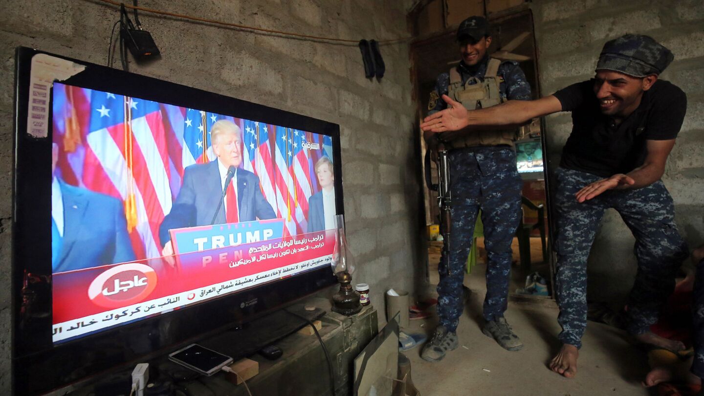 Iraqi forces react as they watch Donald Trump give a speech after winning the U.S. presidential election. They were taking a rest in the village of Arbid on the southern outskirts of Mosul on Nov. 9 during the operation to retake Mosul from Islamic State.