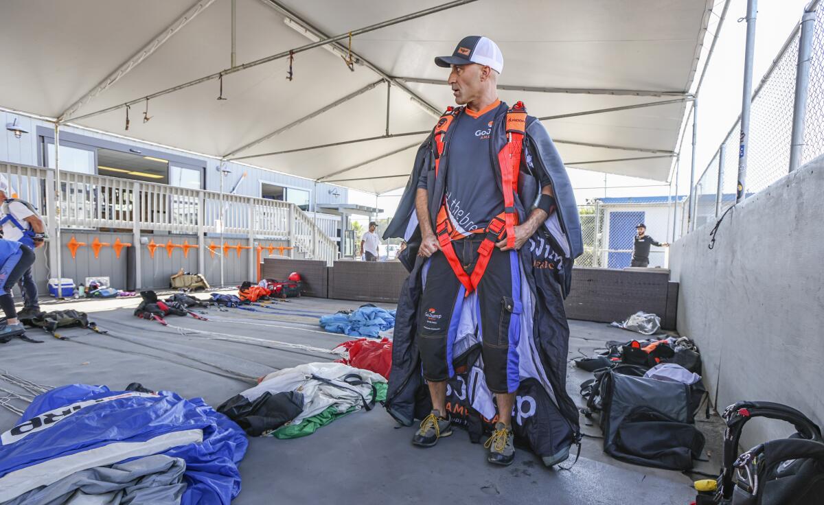 Chris Geiler gets dressed for a wingsuit flight on Thursday at GoJump Oceanside.