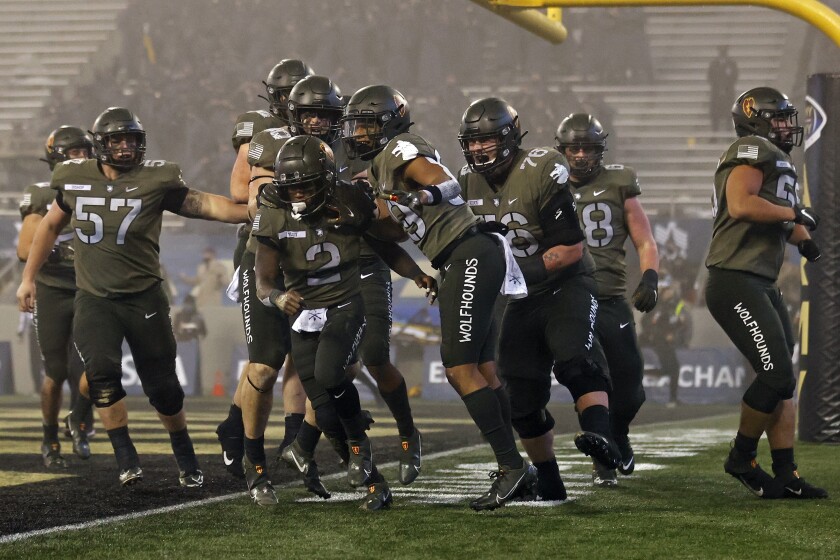 Army quarterback Tyhier Tyler (2) celebrates his fourth-quarter, four-yard touchdown run.