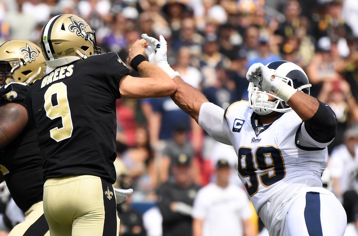 Rams defensive lineman Aaron Donald hits Saints quarterback Drew Brees' throwing hand.