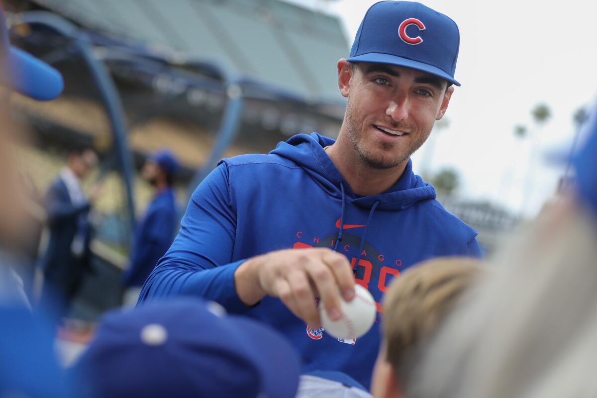 Chicago Cubs center fielder Cody Bellinger signs autographs for fans before Friday's game.