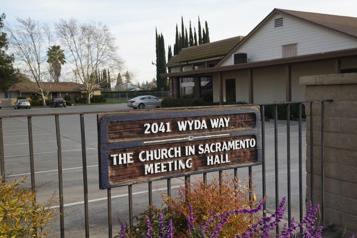 A sign on a fence reads 2041 Wyda Way, The Church in Sacramento Meeting Hall 