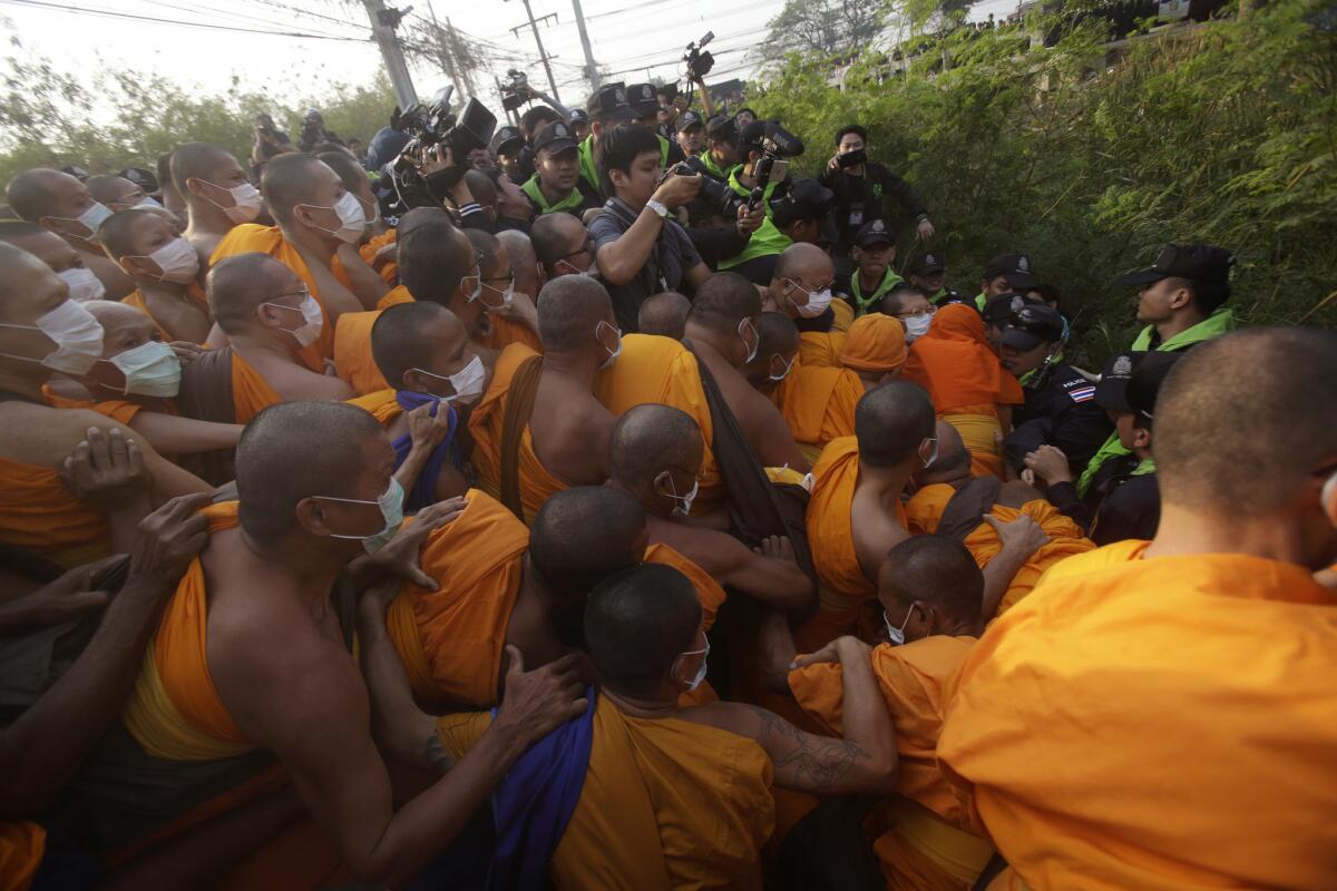 Buddhist monks of the Dhammakaya sect clashed with Thai policemen attempting to arrest spiritual leader Phra Dhammachayo outside their temple north of Bangkok on Feb. 20.
